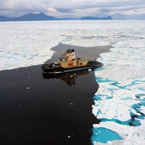 Drone shot of icebreaker ship in frozen Arctic sea