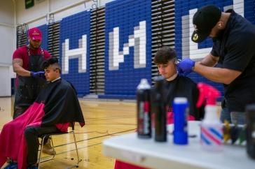 Students getting haircuts in Lundholm Gym